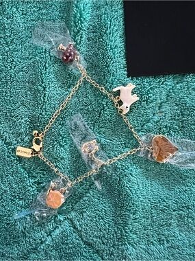 Coach Creature Multi Charm Bracelet crafted in gold-tone plated brass.